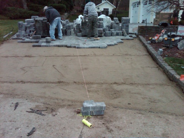 Pitching and Rolling the paver driveway to Perfection.